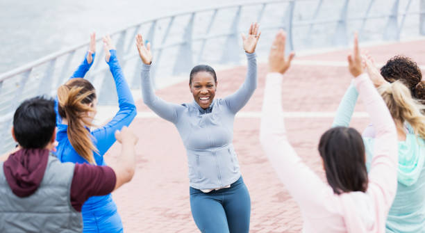 istock African-American woman leading dance exercise class 1301118431
