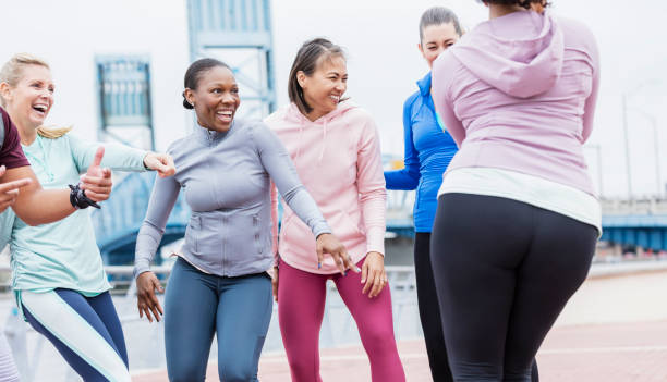 istock Multi-ethnic group of adults dancing outdoors 1301118467