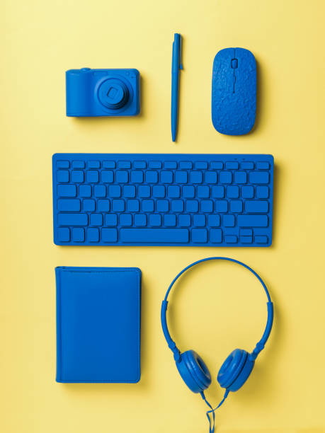 istock Neatly stacked blue workplace accessories on a yellow background. Flat lay. 1301118643