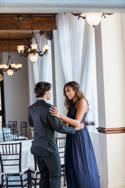 istock Teenage couple dressed for prom, slow dancing 1301118743