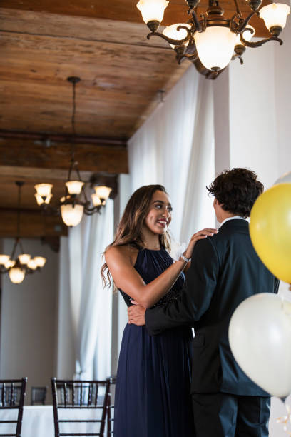 istock Teenage couple dressed for prom, slow dancing 1301118764