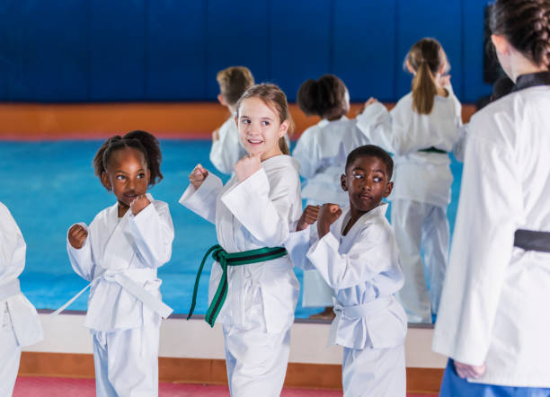 enfants prenant le cours de taekwondo avec l’instructeur - child sport karate education photos et images de collection