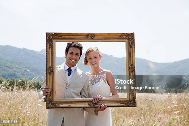 Newlyweds Holding Vintage Picture Frame Stock Photo - Download Image Now - Wedding, Picture Frame, Bride