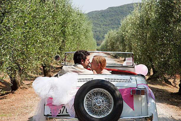 pareja de recién casados besando a en coche clásico - portoferraio fotografías e imágenes de stock