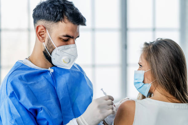istock Woman having Vaccine Injection 1301124223