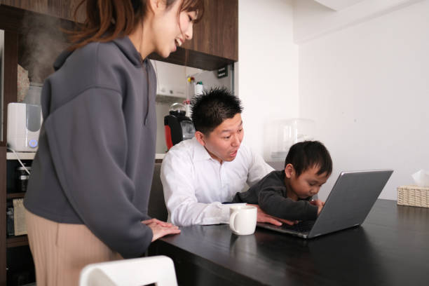 istock Father and mother working from home with child 1301124264
