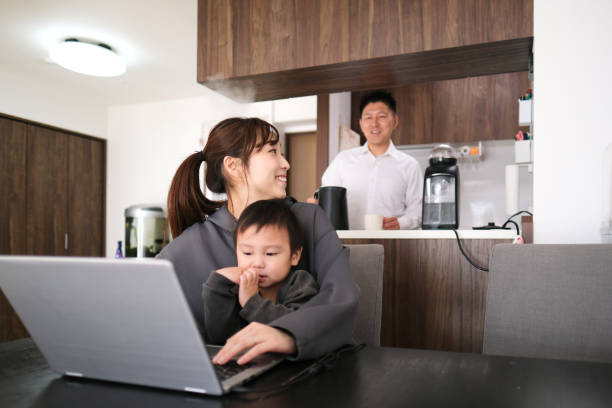 istock Mother and father working from home with child 1301124286