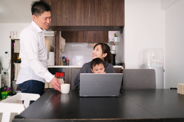 istock Mother and father working from home with child 1301124302