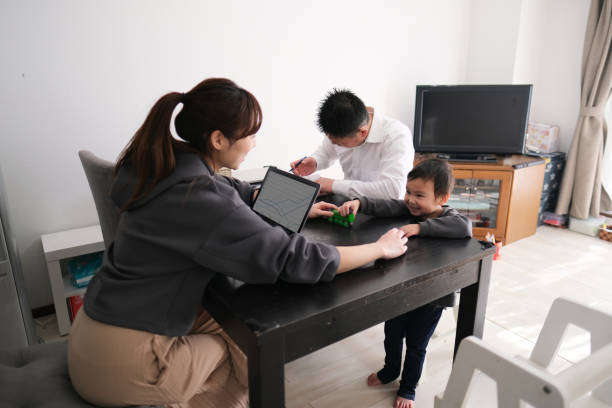 istock Father and mother working from home with child 1301124424