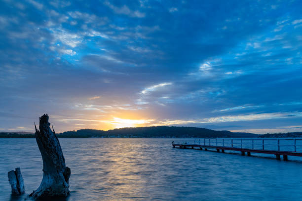 istock Sunrise at the waterfront with cloud cover 1301125379