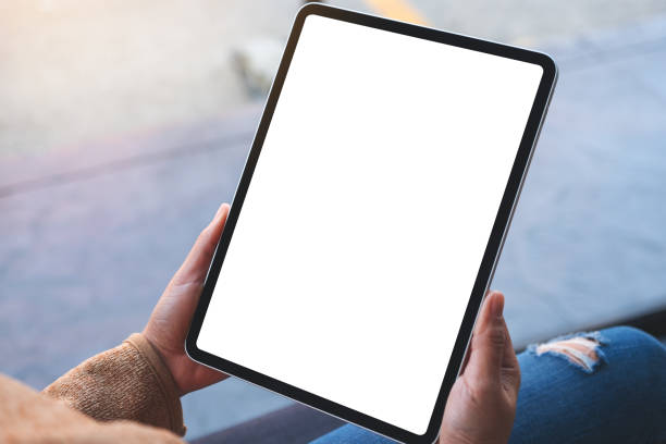 istock a woman holding digital tablet with blank white desktop screen 1301125702