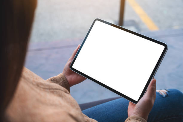 istock a woman holding digital tablet with blank white desktop screen 1301126320