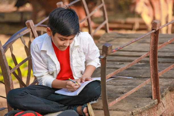 istock little boy seating on bull cart and studying 1301127252