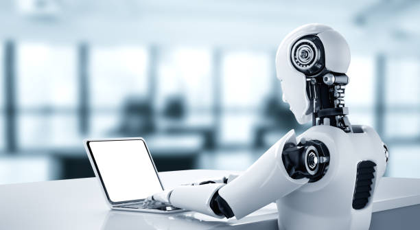 istock Robot humanoid use laptop and sit at table in future office 1301127292