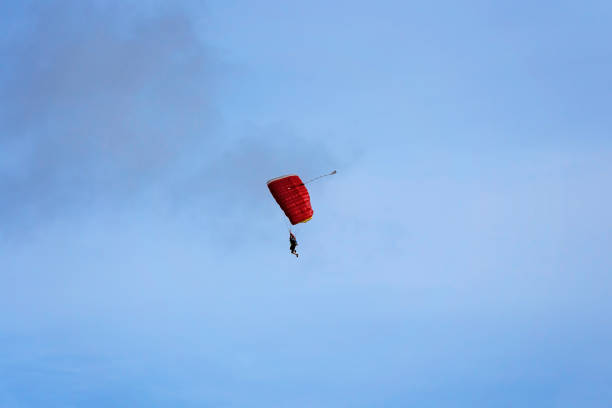 istock Tandem skydivers against a clear blue sk 1301127605