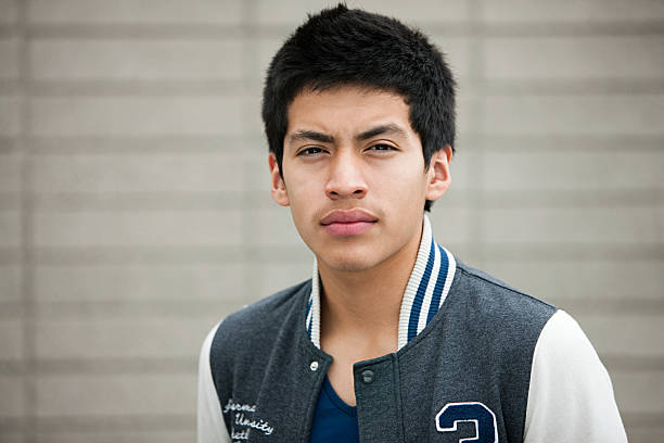 young man wearing baseball jacket, portrait - alleen één tienerjongen stockfoto's en -beelden