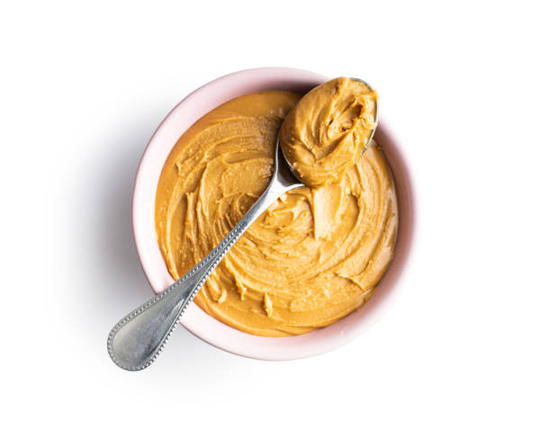 istock Peanut butter in bowl and peanuts 1301132246