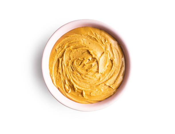 istock Peanut butter in bowl and peanuts 1301132247