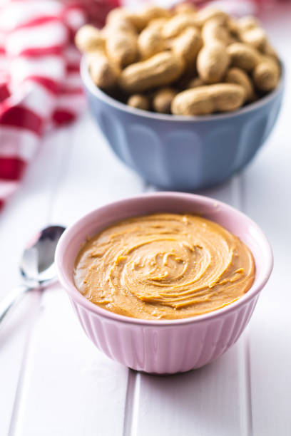 istock Peanut butter in bowl and peanuts 1301132262