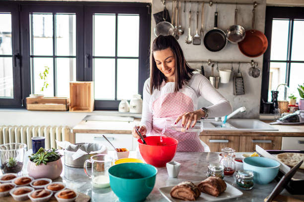 istock Young woman preparing food at kitchen 1301133396