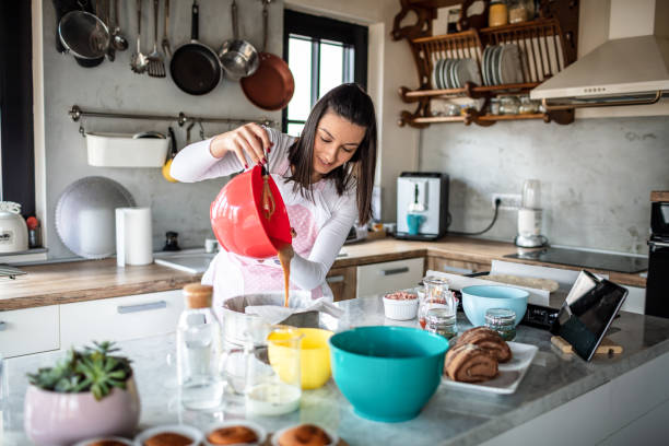 istock Young woman preparing food at kitchen 1301134050