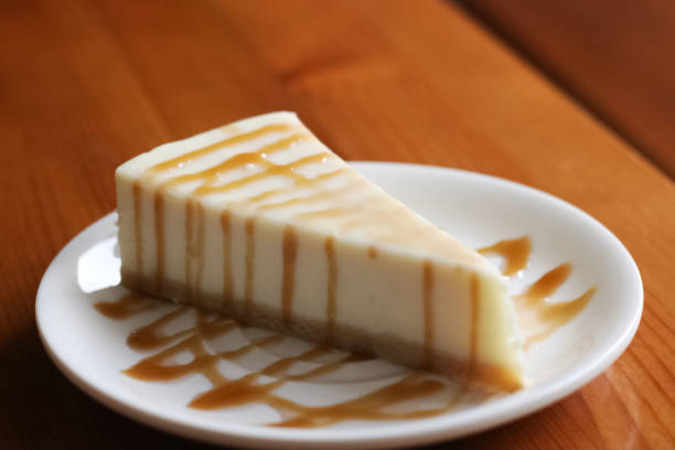 istock Cheesecake with caramel close up on a wooden table 1301134183
