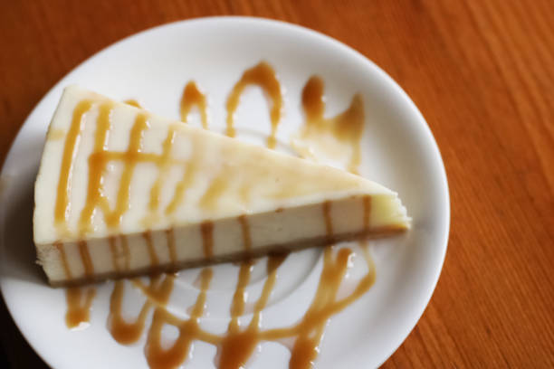 istock Cheesecake with caramel close up on a wooden table 1301134189