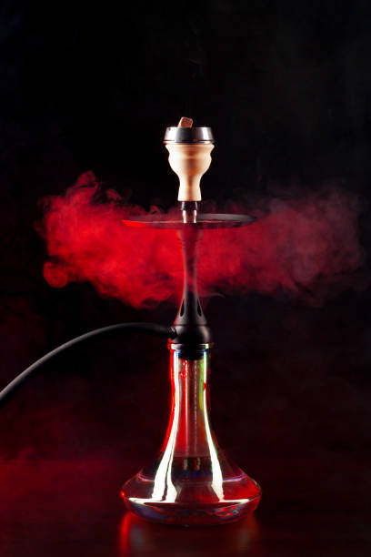 istock Smoking hookah on black background with color fog 1301134193