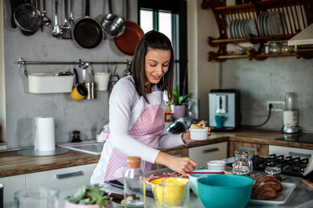 istock Young woman preparing pizza 1301134270