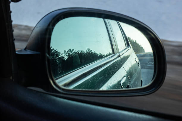 istock The reflection in mirror of car road and forest 1301134358