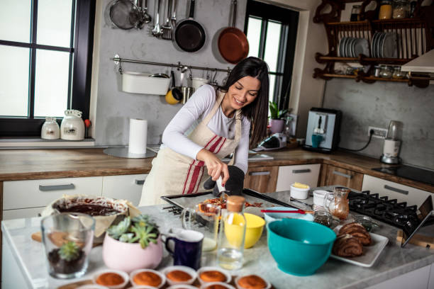 istock Young woman preparing pizza 1301134378