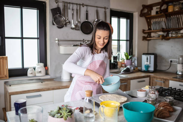 istock Young woman preparing pizza 1301134494