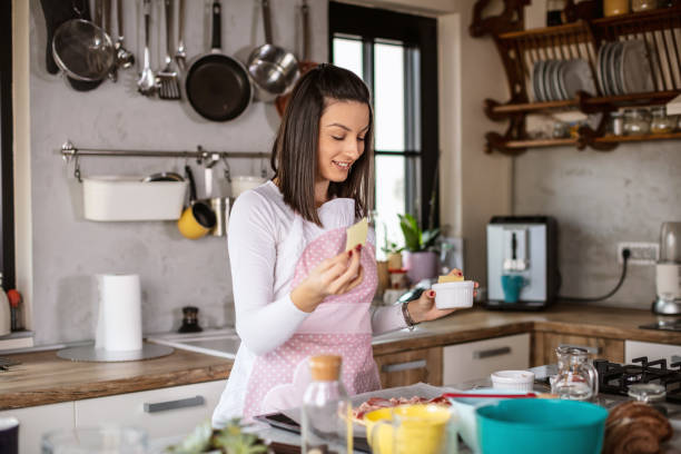 istock Young woman preparing pizza 1301134533