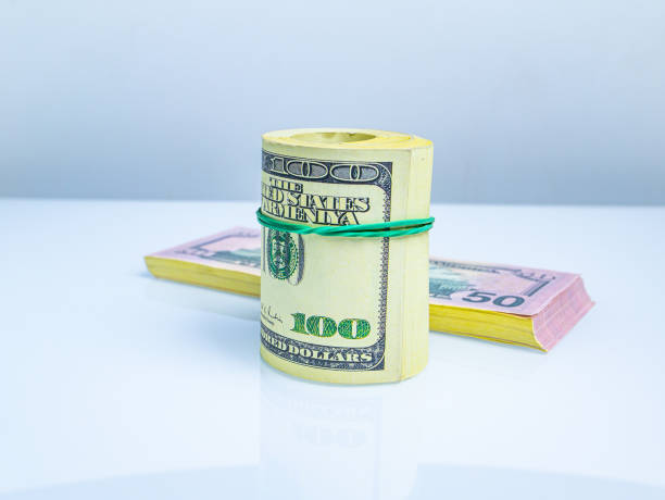 istock A bundle of American dollars money rolled into a roll. 1301136046