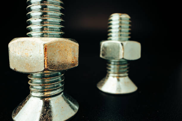istock Metal screws and nuts on black background 1301136069