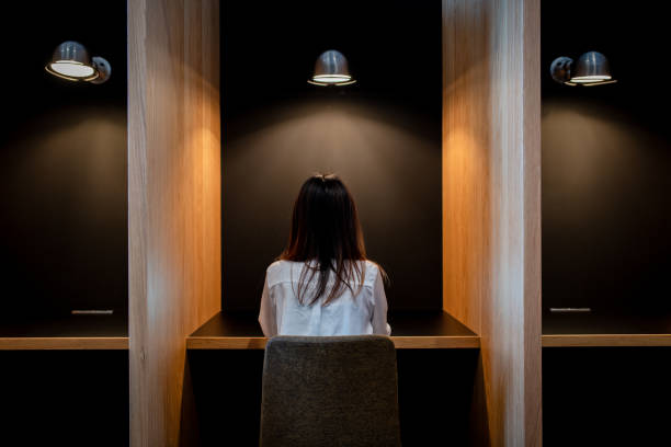 istock Businesswoman working alone in a cubicle 1301137304