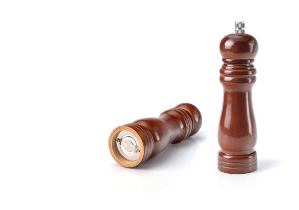 Wooden pepper mill on white insulated background.Close-up.Horizontal view.