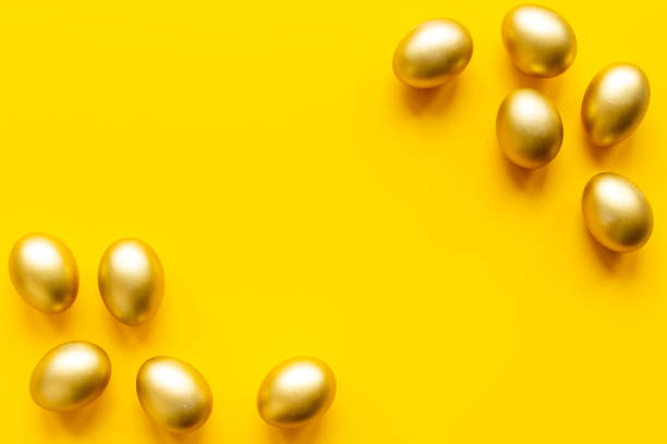 istock Golden eggs on yellow. Easter decoration background. Top view 1301138034