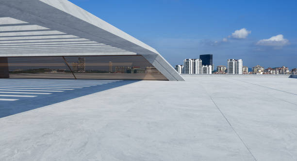 istock Perspective view of empty concrete floor and modern rooftop building 1301138069