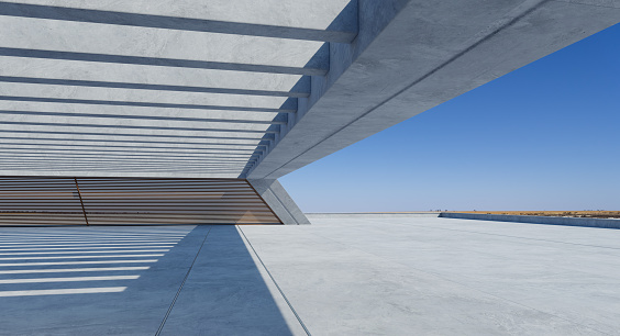 Perspective view of empty concrete floor and modern rooftop building with blue sky. Mixed media