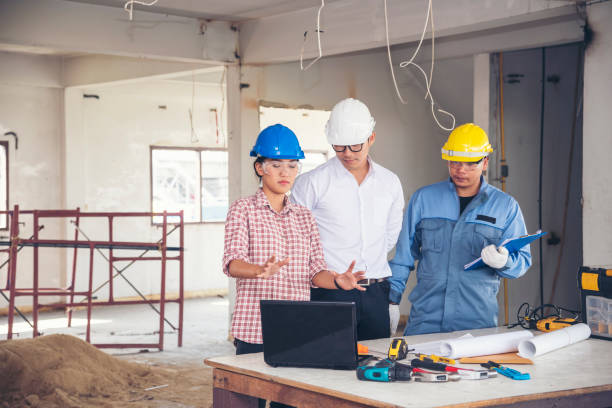 istock Construction engineer teamwork Safety Suit Trust Team Holding White Yellow Safety hard hat Security Equipment on Construction Site. Hardhat Protect Head for Civil Construction Engineer Concept 1301139979