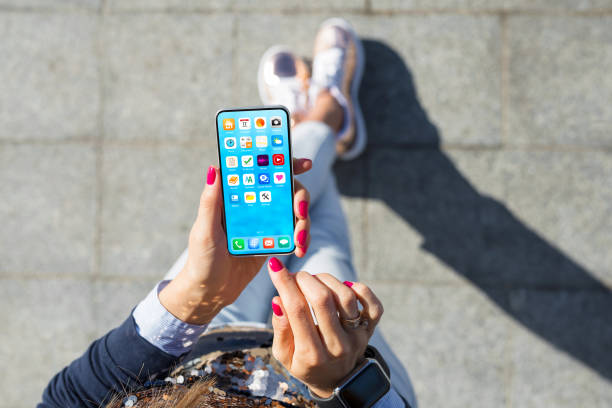 istock Woman using mobile phone, home screen mockup with app icons 1301140206