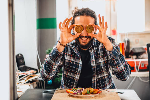 istock Young Man Holding Falafel in His Eyes 1301140336