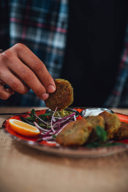 istock Dipping Falafel in Sauce 1301140372