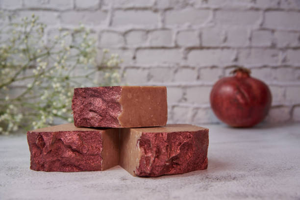 istock Bright handmade soap and garnet on a gray countertop against a brick wall. 1301141264