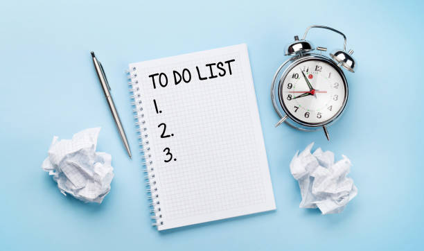 istock Office desk with supplies, alarm clock and to do notepad 1301141274