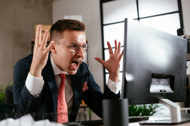 istock Exhausted businessman working on computer in the office. 1301141278