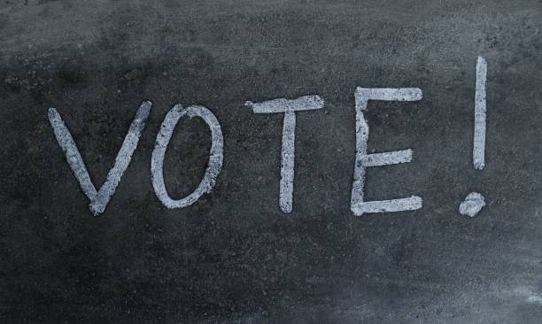 istock Vote Word Written on Blackboard with Exclamation Mark 1301141288