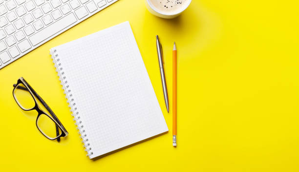 istock Office desk with supplies, coffee and blank notepad 1301141314