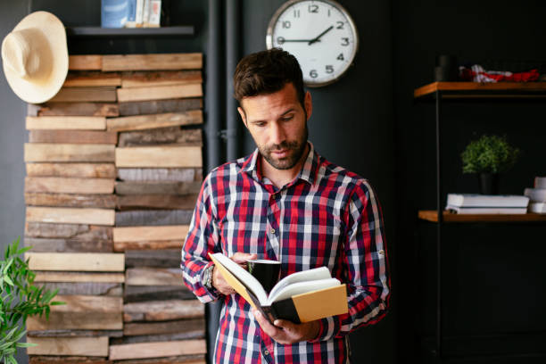 istock Businessman reading a book and drinking coffee. 1301141562
